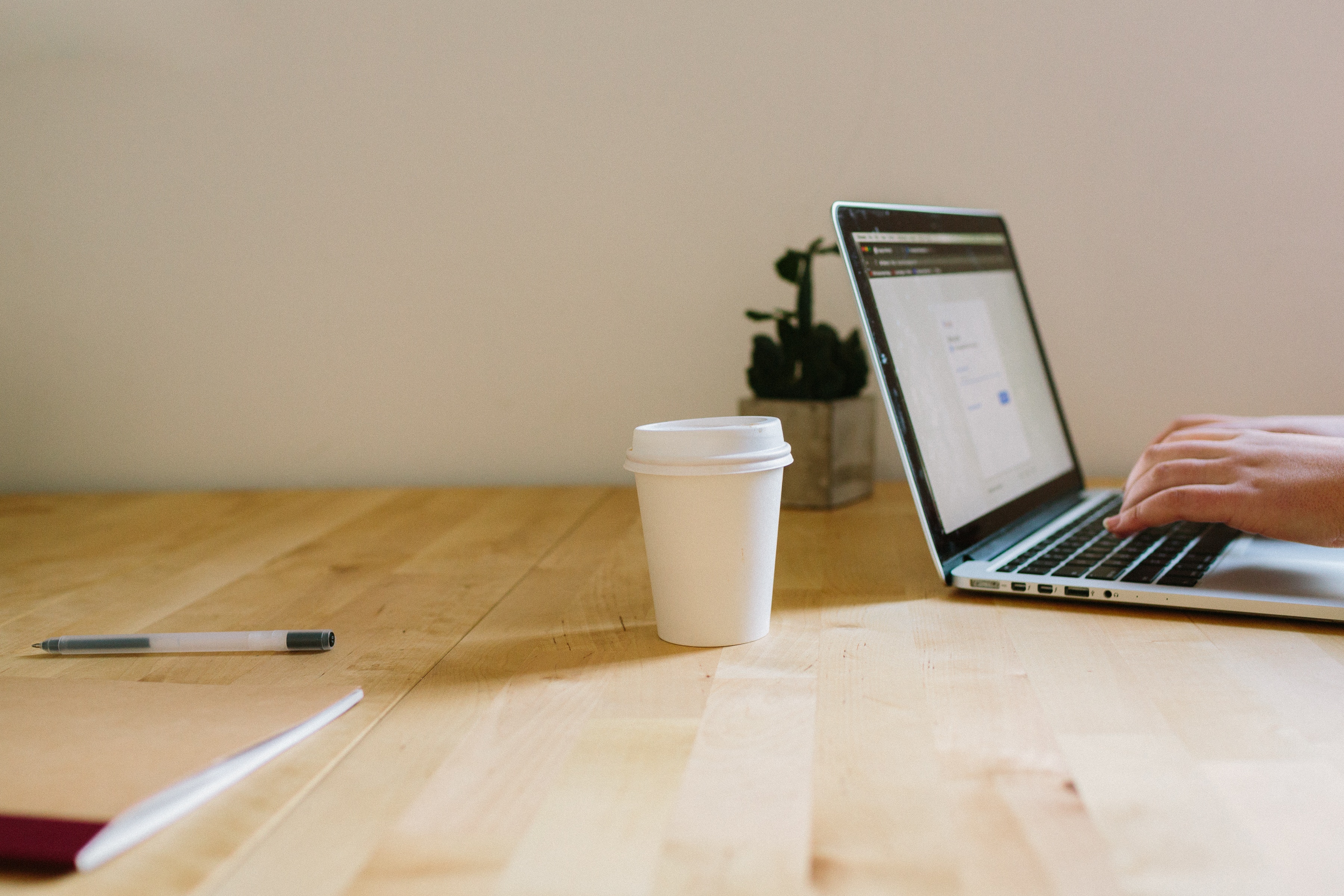 Laptop and coffee Laptop being used on desk with coffee cup