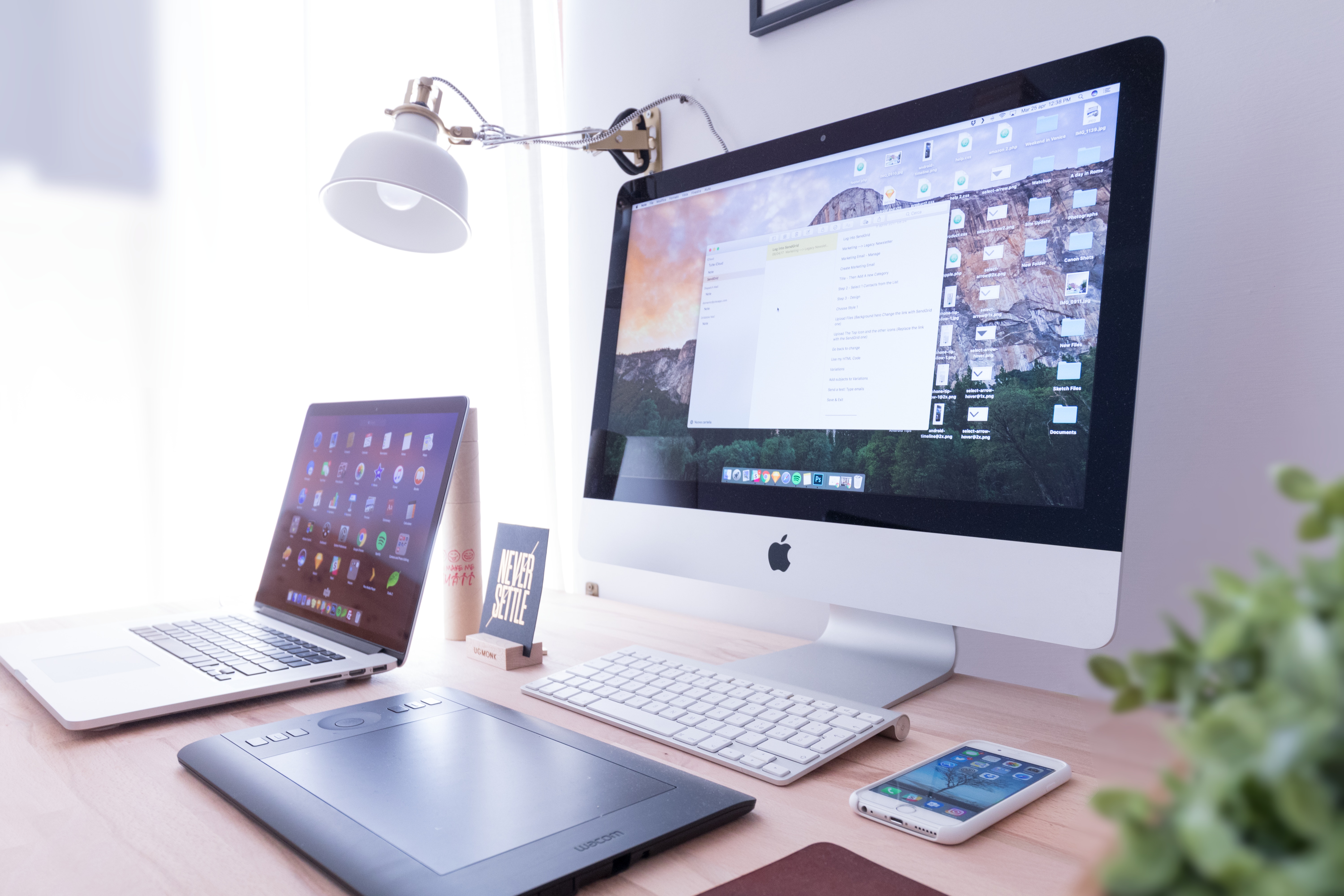 Desktop computer, laptop computer, smart phone, and tablet on a desk Desktop computer, laptop computer, smart phone, and tablet on a desk