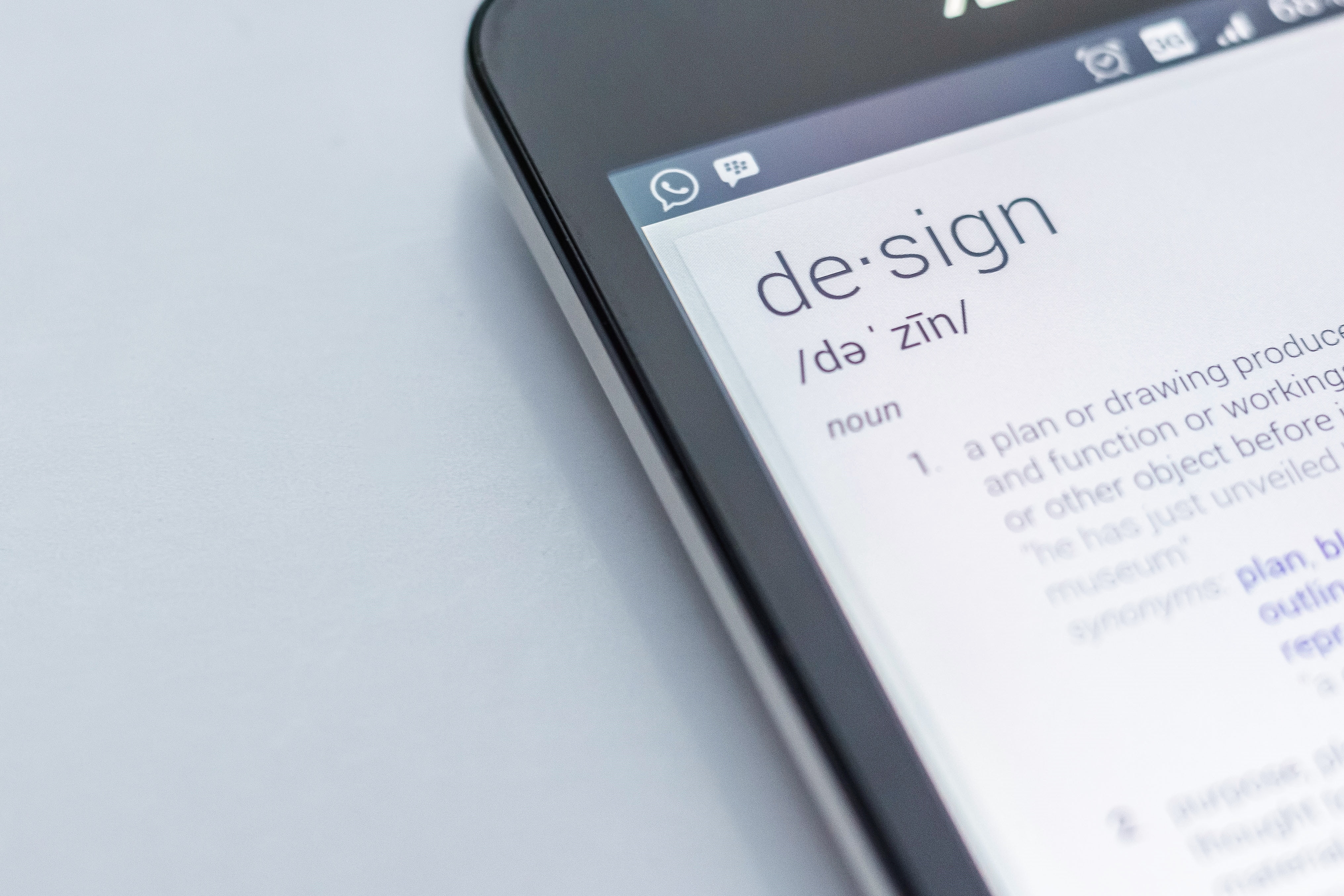 Design smartphone definition Close up of the definition of design on a smartphone.