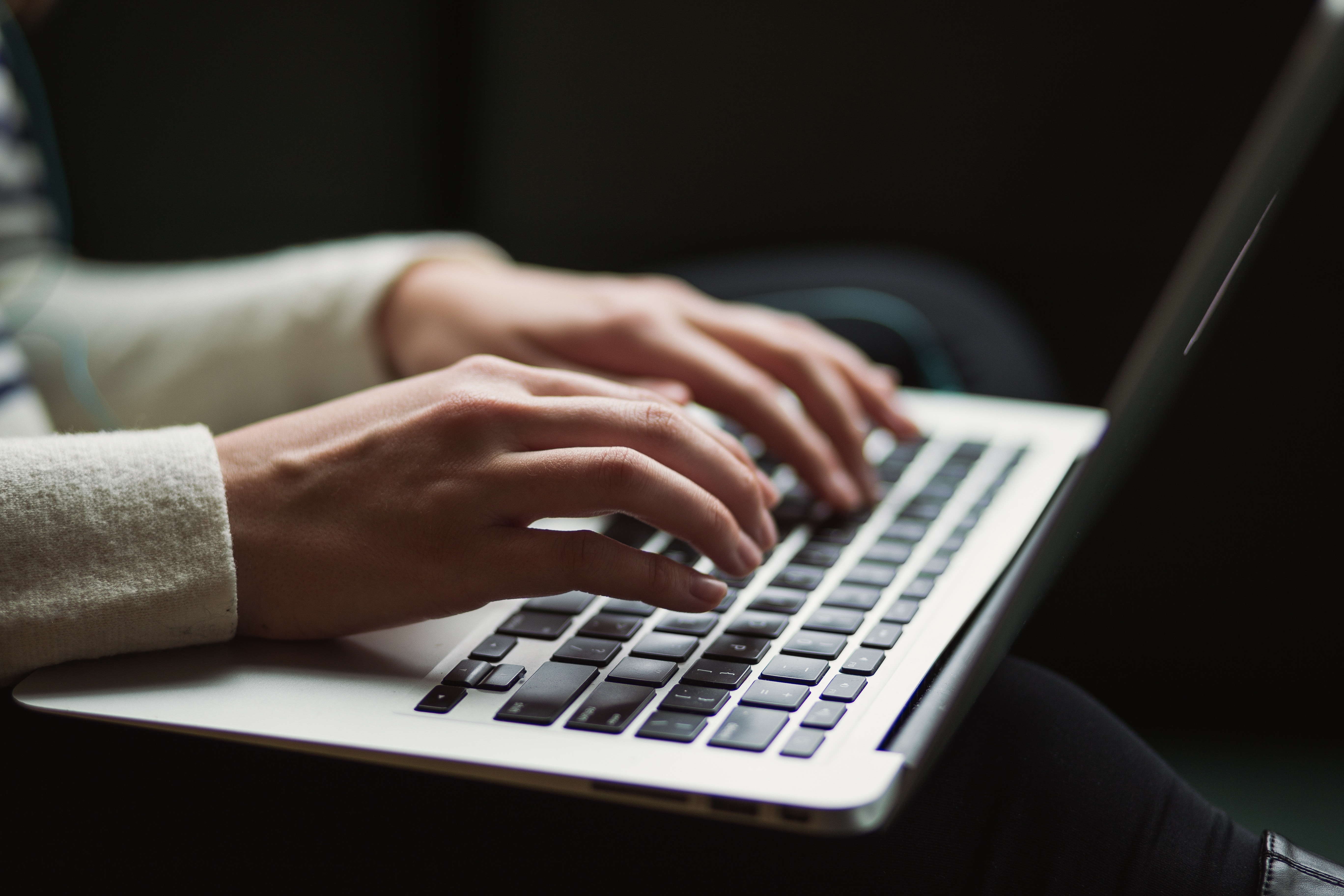 Person typing on laptop Person typing on laptop