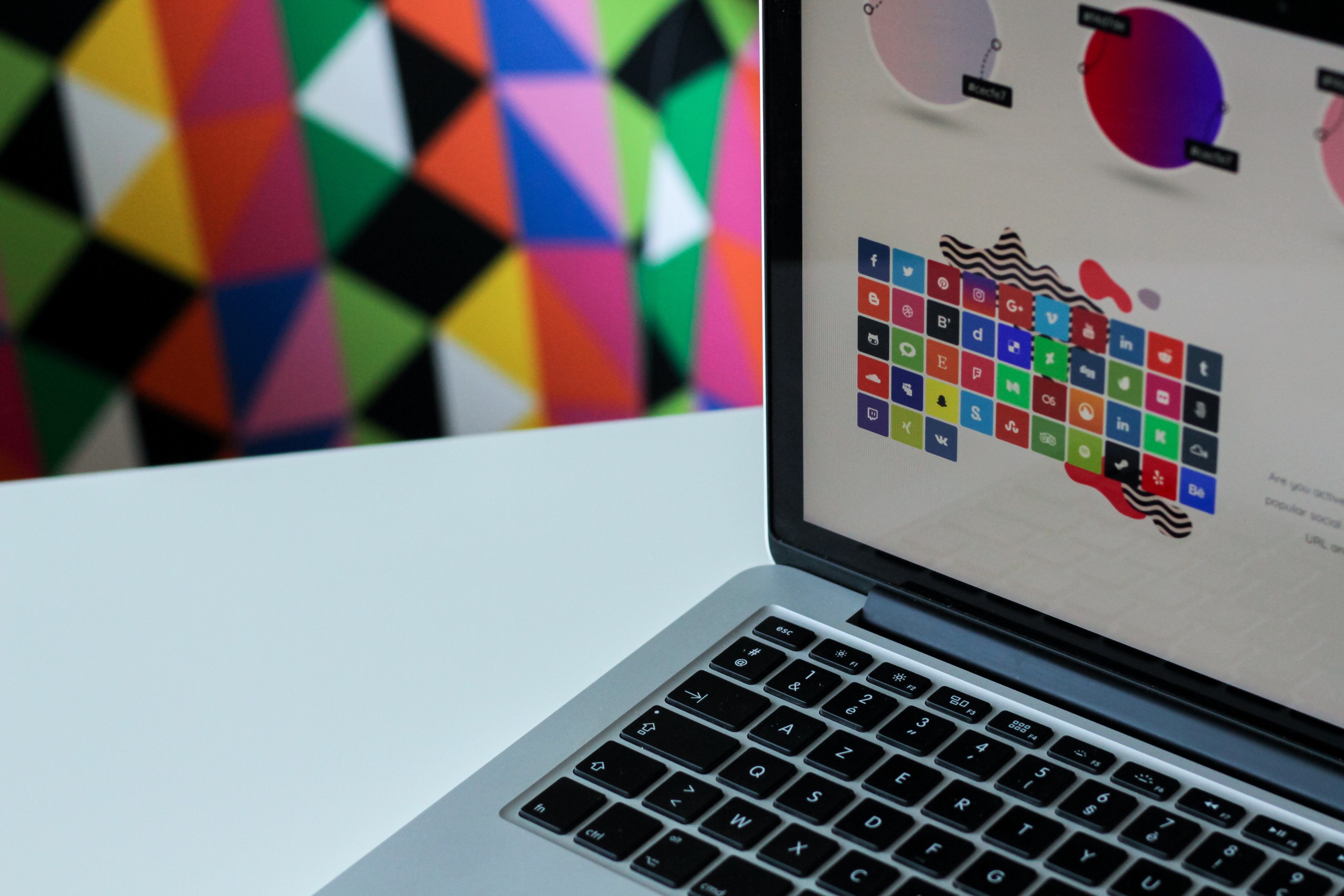 The Value of A Design System Laptop screen with colorful logos.