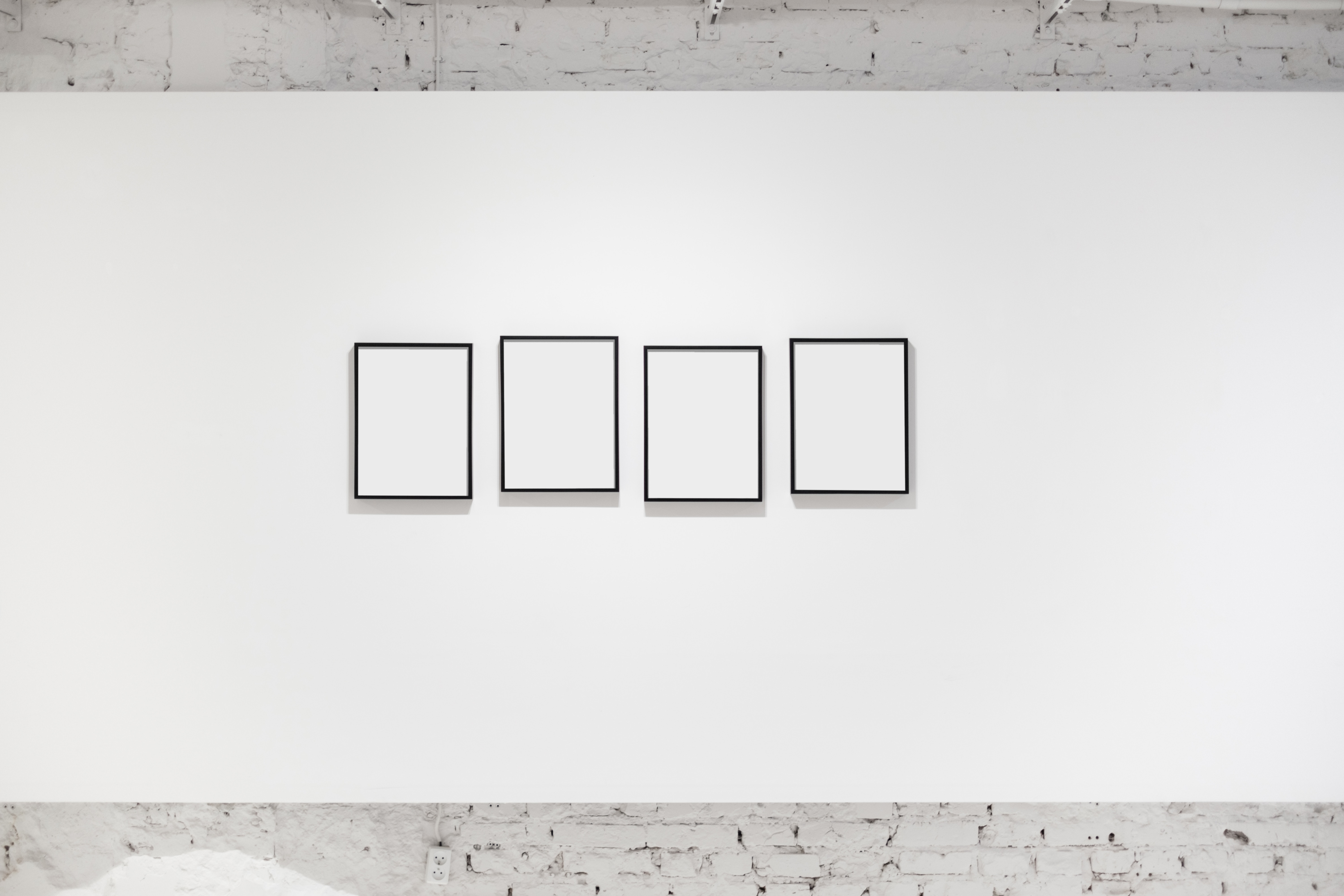 White wall with frames