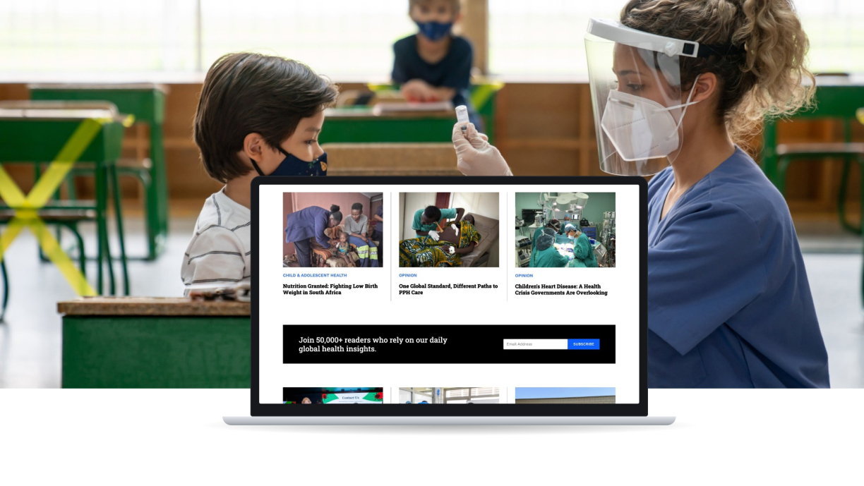 Global Health NOW homepage article grid on a laptop over a photo of a health worker preparing a vaccine for a child
