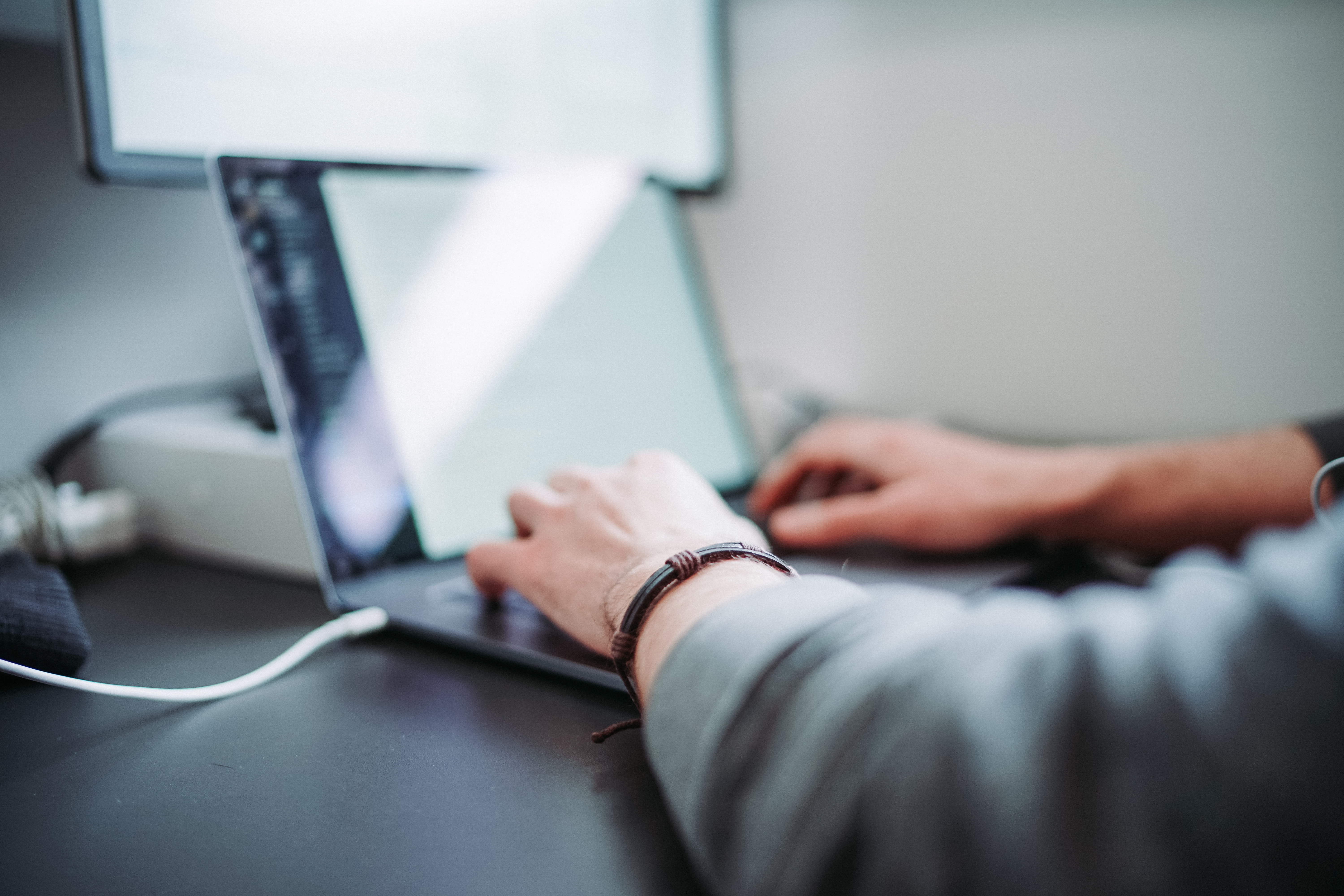 Hands typing on a laptop Hands typing on a laptop